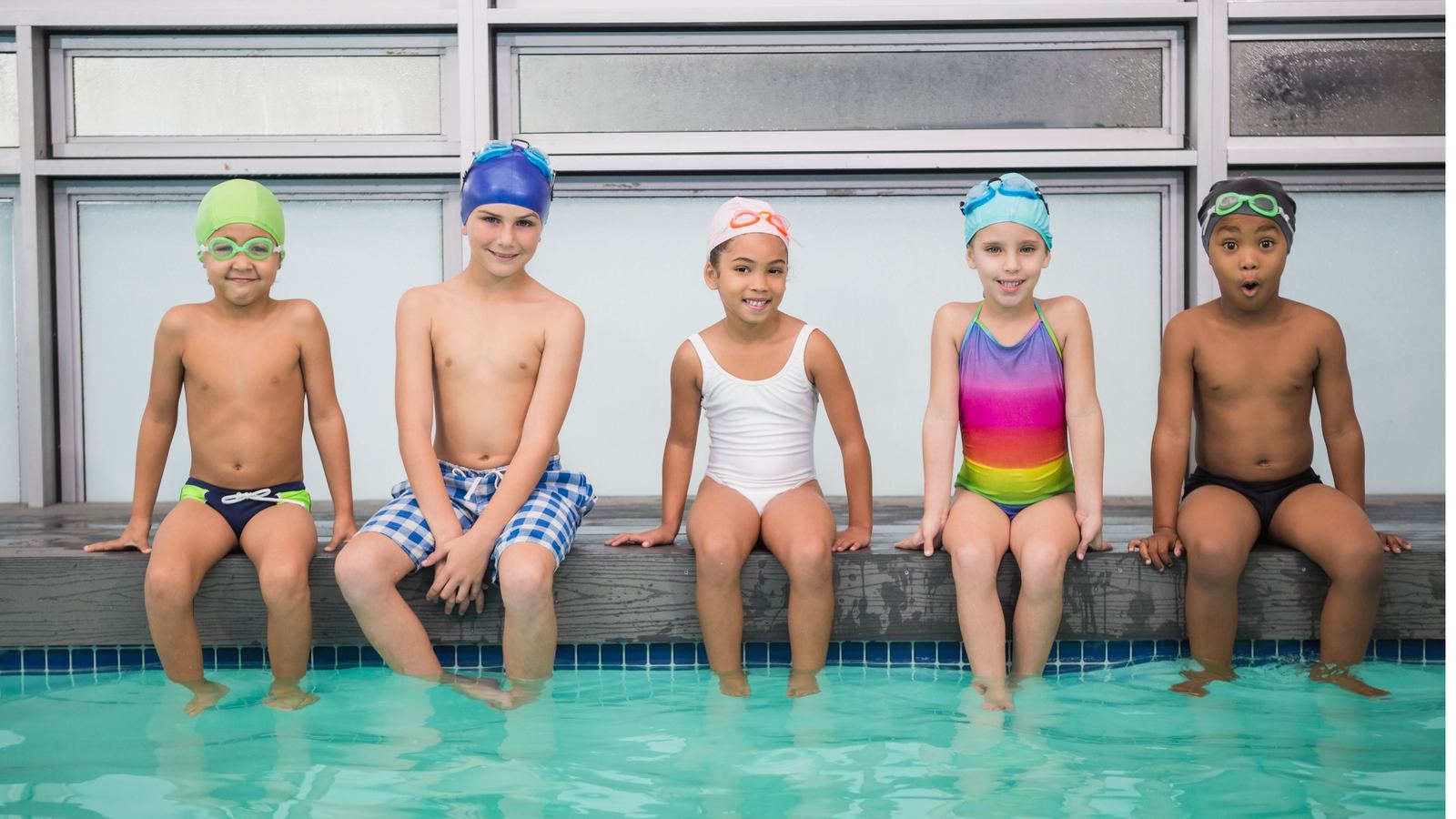 Children sitting along the edge of the Swimmable pool