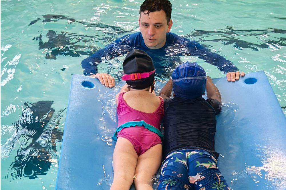 A Swimmable coach supporting a child in the water
