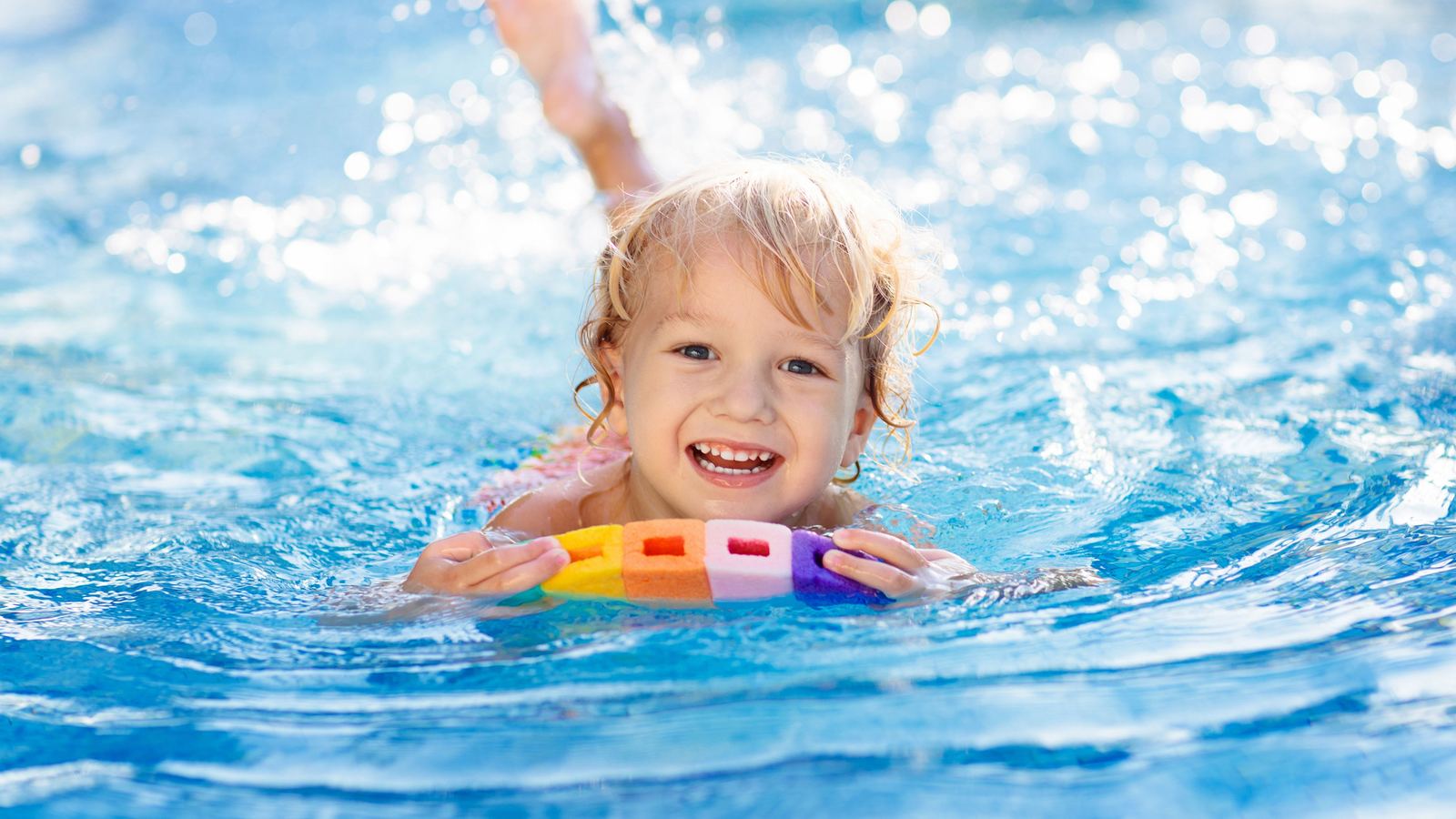 A young swimmer smiling in the Swimmable pool